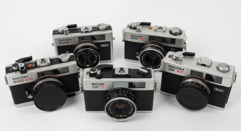 RIKEN: Five c. 1970s rangefinder cameras - one Ricoh 500 G with Rikenon 40mm f2.8 lens, one Ricoh 500 GX with Color Rikenon 40mm f2.8 lens and lens cap, one Ricoh 35 ZF with Rikenon 40mm f2.8 lens and lens cap, one Ricoh 500 ZF with Color Rikenon 40mm f2.