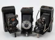 VARIOUS MANUFACTURERS: Three vertical-folding cameras - one Agfa Standard 254 with Anastigmat 105mm f4.5 lens, one Wigin Auta with Cassar 105mm f3.8 lens, and one Siwa model with Radionar 105mm f4.5 lens&nbsp;and shutter release cable. (3 cameras)