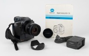MINOLTA: RD-175 SLR camera [#13707010], c. 1995, with AF Zoom 24-85mm f3.5-4.5 lens [#21692210], together with front lens cap, strap, lens hood, power cable, instruction booklet, and software floppy disks. One of the first digital SLR cameras ever produce - 2
