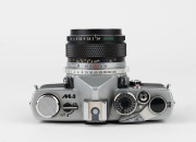 OLYMPUS: 1972 chrome-body Olympus M-1 SLR camera [#116270] with OM-System Auto-S 50mm f1.4 lens [#136192]. - 4