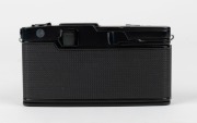 OLYMPUS: Black-body Pen FT half-frame SLR camera [#329944], c. 1967, with D. Zuiko Auto-S 38mm f2.8 lens [#100904] and Olympus S-45 lens hood. - 3