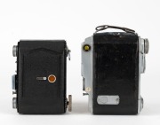 MINOLTA: Two vertical-folding cameras - one 1935-type Semi Minolta I with Coronar 75mm f4.5 lens [#71100] and Crown shutter, and one Auto Semi vertical-folding camera [#8972], c. 1937, with Promar 75mm f3.5 lens [#51583] and Crown Rapid shutter. (2 camera - 3
