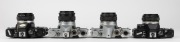 OLYMPUS: Four c. 1970s SLR cameras - one Olympus OM-1 [#527710] with G. Zuiko Auto-S 50mm f1.4 lens [#264437], one Olympus OM-1 MD [#860689] with G. Zuiko Auto-S 50mm f1.4 lens [#350643], one black-body Olympus OM-10 [#1646098] with Zuiko Auto-S 50mm f1.8 - 4