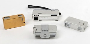 MINOLTA: Four c. 1960 subminiature cameras - one Minolta 16 II in gold [#529082], one Minolta 16 II in silver [#703470], one Minolta 16 II in silver with accessory shoe/tripod mount attachment [#929955], and one Minolta 16 EE II [#274733] with wrist strap