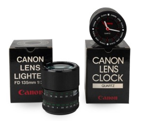 CANON: Two rare novelty items disguised as Canon FD lenses, in black maker's boxes - one quartz 'Canon Lens Clock', and one 'Canon Lens Cigarette Lighter FD 135mm f2.8', both made in Japan.