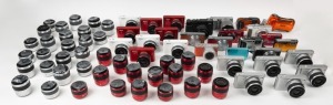 VARIOUS MANUFACTURERS: Sixty-eight promotional dummy camera items, comprising sixteen dummy Nikon 1 digital cameras in red, white, and grey variants, thirty-eight dummy Nikkor lenses in red and white variants, and fourteen dummy digital cameras of various brands/models including Olympus, Fujifilm, and Panasonic. (68 items)