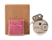 SAKURA SEIKI: Round-body Petal subminiature camera, c. 1948, in maker's wooden box with spare film and instruction sheet. 'Made in Occupied Japan' engraving on rear.