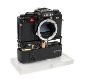 LEITZ: Black Leica R4 camera body and R4 Motor Winder cutaway model, c. 1980, mounted on transparent base with 'Ernst Leitz Wetzlar GMBH' engraving.