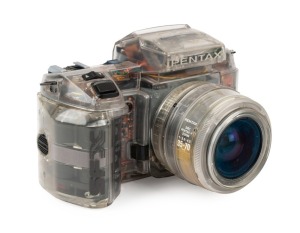 ASAHI KOGAKU: Rare transparent Pentax SFX SLR camera [#3767834], c. 1987, with SMC Pentax-F Zoom 35-70mm f3.5-4.5 lens.