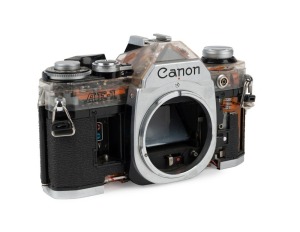 CANON: Partially-transparent Canon AE-1 camera body cutaway model [#209457], c. 1976.