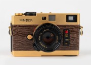 MINOLTA: Gold-edition Minolta CLE rangefinder camera [#2000400] with brown lizardskin covering, c. 1981, with M-Rokkor&nbsp;40mm f2 lens [#2120649] and lens cap. - 2