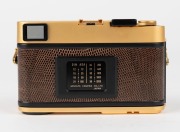 MINOLTA: Gold-edition Minolta CLE rangefinder camera [#2000400] with brown lizardskin covering, c. 1981, with M-Rokkor&nbsp;40mm f2 lens [#2120649] and lens cap. - 3