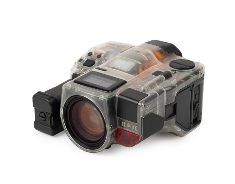 RIKEN: Transparent-body Ricoh Mirai SLR camera [#47109329], c. 1988, with Ricoh Zoom 35-135mm f4.2-5.6 lens. Believed to be one of less than twelve to be produced.