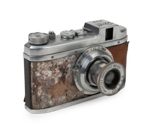 RIKEN: Rare c. 1941 Ricohl Mod. 1 127 film camera [#3600], featuring unusual brown leather covering, with Gokoku Anastigmat 50mm f3.5 lens [#11923]. One of only approximately 1500 believed to have been produced.