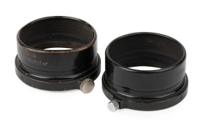 LEITZ: Two rare black c. 1935 FISON lens hoods, each with a different screw type, one featuring 'Germany' export engraving. (2 items)