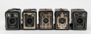 KODAK: Five c. late 1930s box cameras - one Six-16 Brownie with metal Art Deco front plate, one North American-market Six-20 Brownie Junior, one Six-20 Brownie Model D, one Six-20 Brownie Model C in leather case, and one Six-20 Brownie Model D with flash - 2