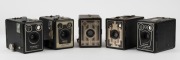 KODAK: Five c. late 1930s box cameras - one Six-16 Brownie with metal Art Deco front plate, one North American-market Six-20 Brownie Junior, one Six-20 Brownie Model D, one Six-20 Brownie Model C in leather case, and one Six-20 Brownie Model D with flash - 3