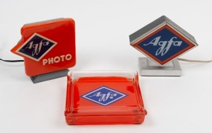 AGFA: Three point-of-sale displays - one metal 18x7.5x15.5cm Agfa lamp, one plastic 17x7.5x16cm Agfa Photo lamp, and one glass 19x18x4cm Agfa coin tray. (3 items)