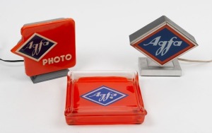 AGFA: Three point-of-sale displays - one metal 18x7.5x15.5cm Agfa lamp, one plastic 17x7.5x16cm Agfa Photo lamp, and one glass 19x18x4cm Agfa coin tray. (3 items)