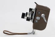 ARCO: Circa 1956 Arco Eight 8mm movie camera [#6148], with ¼"/½"/1½" f1.4 lenses in triple-turret with matching metal lens caps and wrist strap attachment. - 3