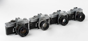 MINOLTA: Four c. 1970s black and chrome SLR cameras - one SRT-200 [#7335848] with MC Rokkor-PF 50mm f2 lens, one SRT MC-II [#9040109] with MC Rokkor-PF 50mm f1.7 lens, one SRT-101 [#1478374] with MC Rokkor-PG 50mm f1.4 lens, and one SRT-101 [#1743742] wit