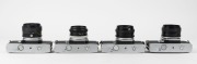 MINOLTA: Four c. 1970s black and chrome SLR cameras - one SRT-200 [#7335848] with MC Rokkor-PF 50mm f2 lens, one SRT MC-II [#9040109] with MC Rokkor-PF 50mm f1.7 lens, one SRT-101 [#1478374] with MC Rokkor-PG 50mm f1.4 lens, and one SRT-101 [#1743742] wit - 6