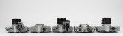 MINOLTA: Five c. 1960s SLR cameras - one SR-7 [#2138944] with front lens cap, one SR-3 [#1232460] with meter attachment and front lens cap, one SR-1 [#1239741] with SR-Meter&middot;2 and front lens cap, one SR-1 body [#2183819]&nbsp;with body cap, and one XG1 body [# - 4