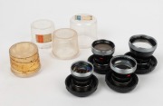 CARL ZEISS: Four c. 1950s Contaflex&nbsp;Pro-Tessar lenses in plastic domes with front lens caps - one 35mm f3.2 [#4684189], one 35mm f4 [#2357491], one 85mm f4 [#1878081], and one 115mm f4 [#3981570]. (4 items) - 2