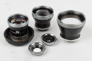 CARL ZEISS: Five c. 1960s lenses - one Pro-Tessar M1:1 [#2768218], one Tessar 50mm f2.8 [#1560784], one Contaflex Pro-Tessar 35mm f4 [#2292838] in plastic dome with lens cap, one Contaflex Pro-Tessar 85mm f4 [#2296661], and one Contaflex Pro-Tessar 115mm 