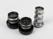 CARL ZEISS: Three lenses - one Sonnar 135mm f4 [#2680027] for Contax rangefinder in maker's box, one Flektogon 35mm f2.8 [#5306880] for Werramatic&nbsp;in plastic dome with lens cap, and one Cardinar 100mm f4 [#6383235] for Werramatic in plastic dome with lens