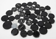 CANON:&nbsp;A mixed assortment of thirty-two black plastic and twelve metal front and rear lens caps, of various diameters. (44 items)