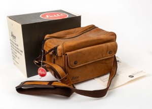 LEITZ: Brown leather Leica camera bag with carry strap, instruction sheet, and original retail swing tag. Featuring the words 'Leica 1913-1983' embossed near base of bag. Comes with original box, indicating that it is designed for the Leica M4-P.