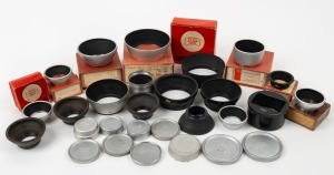 ZEISS IKON: Twenty-eight photography accessories of various diameters (eight of which in maker's boxes), comprising eleven metal lens hoods, seven rubber or plastic lens hoods, and ten lens caps with such inscriptions as 'Zeiss Opton', 'Zeiss Ikon', and 'Carl Zeiss'. (28 items)