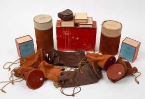 ZEISS IKON: An accumulation of sixteen accessory containers of various sizes, comprising seven leather lens pouches, two lens tubes, six boxes, and one leather lens filter pouch. (16 items)