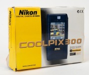 NIPPON KOGAKU: Five c. late 1990s digital cameras showcasing several daring early design choices - one Coolpix 100, one Coolpix 300 with unusual coupled touchscreen PDA and voice memo feature, one Coolpix 900, one Coolpix 5000 with coupled MB-E5000 batter - 3