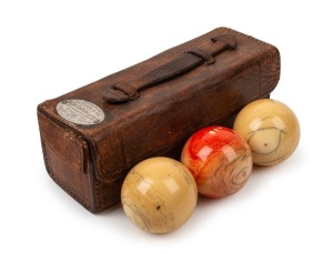 IS THIS WALTER LINDRUM'S EARLIEST AWARD? A leather carrying case containing three ivory presentation billiard balls; the top of th case bearing a silver plaque engraved to read "Presented by ALCOCK & CO. to Walter Lindrum, (age 16 years) to commemorate his Break of 434 in CHAMPIONSHIP MATCH 1915.", 18.5cm long, 7cm deep, 7cm wide.