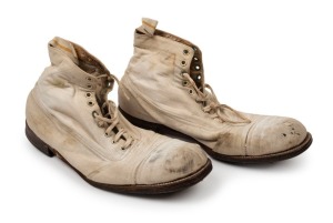 Circa 1934 pair of Cricket Boots; well made of white canvas on the outer with tan leather soles stamped "DERWENT..."; each boot with 11 studs on each boot, the lace-ups with 9 pairs of eyelets. (2). Worn by Grimmett during his final season with the Austra