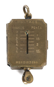 Stamp Boxes - Brass: c.1890 small stamp box (14x31mm) incorporating a minute spring-loaded letter scale, with weight and rate information on the face, Registration No '102604', weight 9gr, in good condition with the spring balance still accurate, ring for attaching to a fob chain. Extremely rare and unusual.