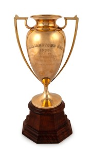 THE WILLIAMSTOWN CUP, 1933 gold cup, engraved "Won By F.E. SHILLABEER & S.E. BAILEY'S, SHADOW KING, Ridden By A. E. BREASLEY" made by THOMAS GAUNT of Melbourne, stamped "T. GAUNT & Co. 15ct", blackwood base also bearing Gaunt's maker's mark, 34cm high overall, 404 grams gold weight.