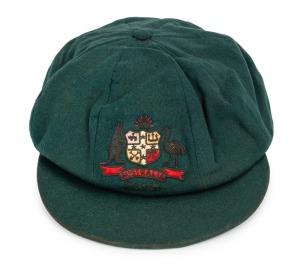 CLARRIE GRIMMETT'S AUSTRALIAN BAGGY GREEN CAP dated 1935-36, for the tour of South Africa, November 1935 to March 1936; green wool with the coat of arms embroidered with gold and silver wire and coloured thread; with the embroidered label of "Farmers SYDN