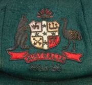 CLARRIE GRIMMETT'S AUSTRALIAN BAGGY GREEN CAP dated 1935-36, for the tour of South Africa, November 1935 to March 1936; green wool with the coat of arms embroidered with gold and silver wire and coloured thread; with the embroidered label of "Farmers SYDN - 2