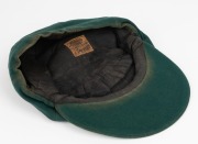 CLARRIE GRIMMETT'S AUSTRALIAN BAGGY GREEN CAP dated 1935-36, for the tour of South Africa, November 1935 to March 1936; green wool with the coat of arms embroidered with gold and silver wire and coloured thread; with the embroidered label of "Farmers SYDN - 4