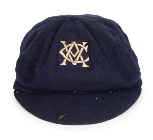 CLARRIE GRIMMETT'S VICTORIAN CRICKET ASSOCIATION Team Cap, dark blue wool, embroidered with the monogrammed initials of the V.C.A. in cream silk thread; label of Buckley & Nunn. Grimmett appeared in five matches as part of the V.C.A. team between 1918 and 1923, before moving to Adelaide in 1924. Provenance: The Clarrie Grimmett Collection; his family, by descent.
