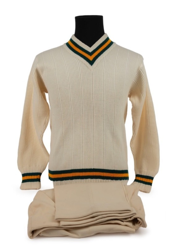 An Australian Cricket Team woollen jumper with printed "Farmers Sydney" label with "C. GRIMMETT" in pen; together with a pair of cricket flannels by Kaylo, with a "GRIPU" waistband label. (2, both appear to be in unworn condition).Provenance: The Clarrie