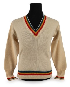 CLARRIE GRIMMETT'S SOUTH AUSTRALIAN TEAM, circa 1930 woollen jumper with blue, yellow and red colours to cuffs and collar; "Australknit S.A." maker's label, "The Big Store John Martin's Mens & Boys Outfitters Adelaide" retailer's label and ownership label with pen "C.V. Grimmett" all present.Provenance: The Clarrie Grimmett Collection; his family, by descent.