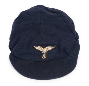 CLARRIE GRIMMETT'S INDIAN CRICKET CAP OF THE PRINCELY KINGDOM OF JATH, 1938, dark blue wool with the State badge embroidered to the rim, "Army & Navy Stores Ltd., Bombay" label to crown, with "GrimmettAt the request of the Maharajah of Jath, Vijayasingh Rao Ram Rao, Grimmett travelled to India to tutor the young royals of Jath in the art of cricket. While there, Grimmett paid special attention to a young all-rounder, who impressed him greatly. This player was Vijay Hazare.