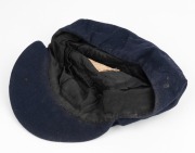 CLARRIE GRIMMETT'S INDIAN CRICKET CAP OF THE PRINCELY KINGDOM OF JATH, 1938, dark blue wool with the State badge embroidered to the rim, "Army & Navy Stores Ltd., Bombay" label to crown, with "GrimmettAt the request of the Maharajah of Jath, Vijayasingh R - 3