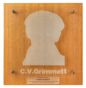 CLARRIE GRIMMETT'S AUSTRALIAN CRICKET HALL OF FAME ETCHED GLASS PLAQUE, with affixed metal plaque below bearing the dedication "Presented to the family of CLARRIE GRIMMETT on the occasion of his induction into the Australian Cricket Hall of Fame at the Melbourne Cricket Ground, December 1996", framed on an ornamental timber backing board, overall 36 x 35cm.