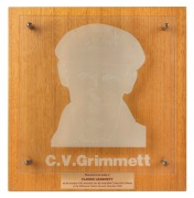 CLARRIE GRIMMETT'S AUSTRALIAN CRICKET HALL OF FAME ETCHED GLASS PLAQUE, with affixed metal plaque below bearing the dedication "Presented to the family of CLARRIE GRIMMETT on the occasion of his induction into the Australian Cricket Hall of Fame at the Me