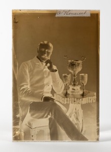 Arthur William FitzRoy Somerset (1855 - 1937), glass plate negative depicting Somerset posing with three of his silver cricket trophies, circa 1905, with his original signature "A F Somerset" affixed on a label at top; 165 x 110mm.